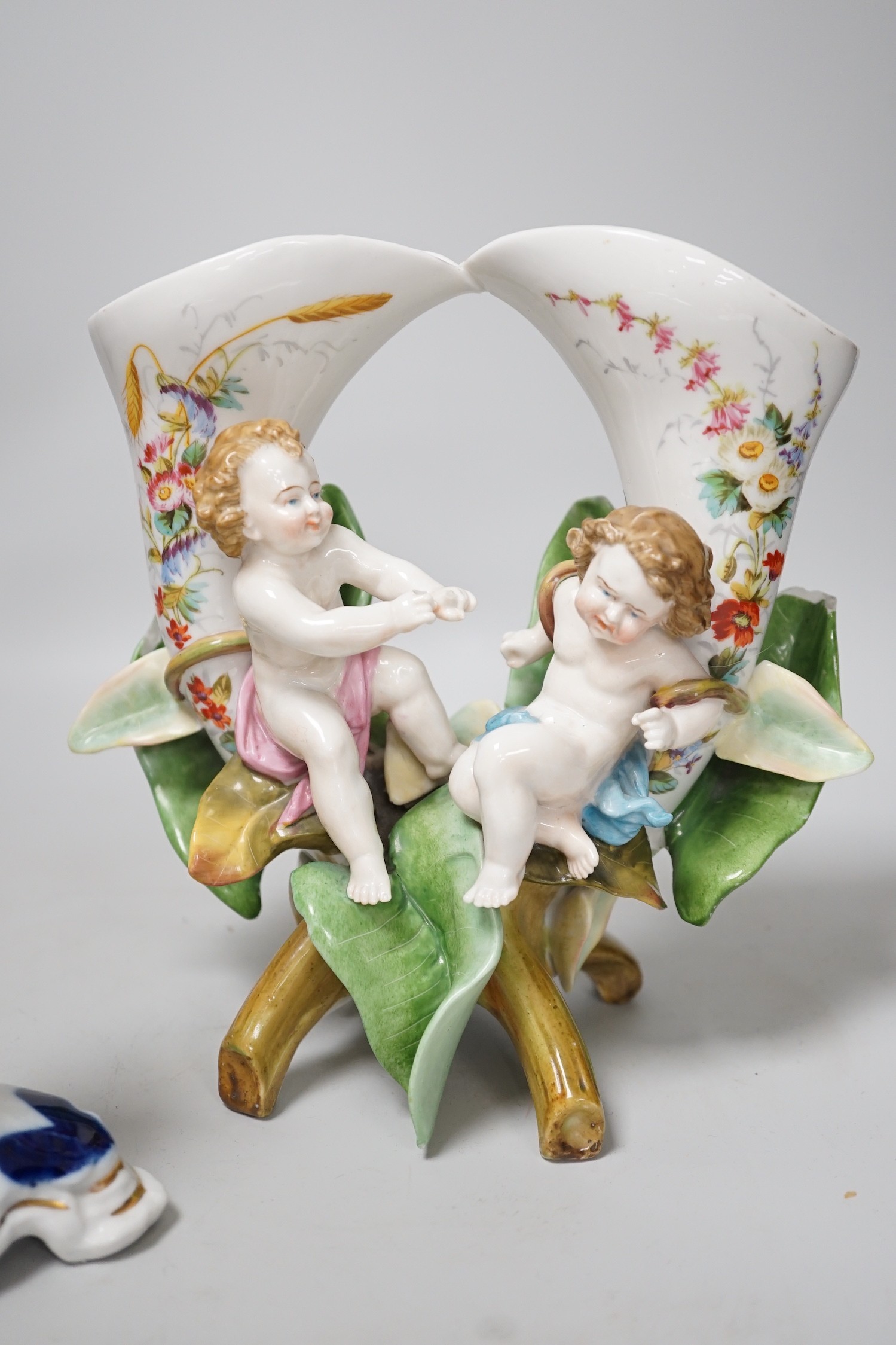 A pair of candlesticks and a figure group flower vase. Tallest 20cm